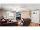 Bright living room with hardwood floors, a TV, comfortable sofas, a ceiling fan, and a sliding door to the patio at 3735 Block House Way # 113, Myrtle Beach, SC 29577
