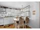 Bright kitchen with white cabinetry, laminate floors, and a dining area at 6001 - 1789 S Kings Hwy., Myrtle Beach, SC 29575