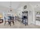 Dining area with a glass table, seating, arched windows, and a view into the kitchen at 703 Riverwalk Dr. # 304, Myrtle Beach, SC 29579