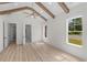 Airy bedroom featuring vaulted ceilings, wooden beams, a ceiling fan, and multiple windows for ample sunlight at 8001 Mcsweeney Ct., Myrtle Beach, SC 29588