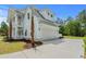 Charming two-story home with a three-car garage, lush landscaping, and inviting curb appeal at 8001 Mcsweeney Ct., Myrtle Beach, SC 29588