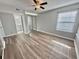Bedroom featuring wood-look flooring, a ceiling fan, and a view into the bathroom from bedroom doorway at 8830 Chandler Dr. # G, Surfside Beach, SC 29575