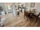 Cozy dining area with seating for four, wood floors, and adjacent kitchen space at 8830 Chandler Dr. # G, Surfside Beach, SC 29575
