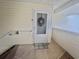 A welcoming front door with a wreath and 'welcome' mat on a covered porch at 8830 Chandler Dr. # G, Surfside Beach, SC 29575
