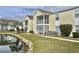 Inviting condo exterior with a screened patio, set near a picturesque pond at 8830 Chandler Dr. # G, Surfside Beach, SC 29575