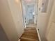 Hallway features wood-look flooring, a closet, and neutral paint throughout leading to another room at 8830 Chandler Dr. # G, Surfside Beach, SC 29575