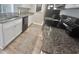 Stylish kitchen featuring granite counters, modern appliances, and updated cabinetry at 8830 Chandler Dr. # G, Surfside Beach, SC 29575