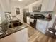 Modern kitchen with granite countertops, stainless steel appliances, and white cabinetry at 8830 Chandler Dr. # G, Surfside Beach, SC 29575