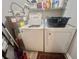 Laundry room features a washer, dryer, shelving, and a water heater with room for laundry accessories at 8830 Chandler Dr. # G, Surfside Beach, SC 29575