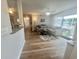 Bright living room with wood floors, a gray sofa, and sliding glass door to outside at 8830 Chandler Dr. # G, Surfside Beach, SC 29575