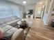 Comfortable living room featuring a sectional sofa, TV, and wood-style flooring at 8830 Chandler Dr. # G, Surfside Beach, SC 29575