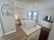 Main bedroom featuring wood-look flooring, a ceiling fan, neutral paint, and a large bed at 8830 Chandler Dr. # G, Surfside Beach, SC 29575