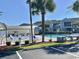 Community pool area with ample seating and a refreshing swimming pool, perfect for relaxation at 8830 Chandler Dr. # G, Surfside Beach, SC 29575