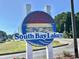 Welcoming 'South Bay Lakes' community sign with bright colors and beachy design at 8830 Chandler Dr. # G, Surfside Beach, SC 29575