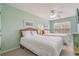 Bright bedroom features two beds, a ceiling fan, and natural light at 118A 6Th Ave. N, Surfside Beach, SC 29575