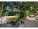 Backyard water feature with a pond, rock accents, lush plantings, and a tranquil ambiance at 1716 Club Circle Dr., Pawleys Island, SC 29585
