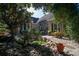 Landscaped backyard with a serene pond, stone accents, and lush greenery at 1716 Club Circle Dr., Pawleys Island, SC 29585