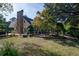Scenic backyard with a stone chimney, manicured lawn, and beautiful landscaping at 1716 Club Circle Dr., Pawleys Island, SC 29585
