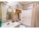 Bathroom with mosaic tiled walls, a walk-in shower and vanity with decorative mirror at 1716 Club Circle Dr., Pawleys Island, SC 29585