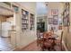 Dining area with wood floors, built-in shelving, and an open view to the kitchen and living area at 1716 Club Circle Dr., Pawleys Island, SC 29585