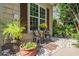 Charming front porch sitting area with decorative pots, seasonal flowers, and a beautiful view at 1716 Club Circle Dr., Pawleys Island, SC 29585