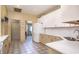 Bright kitchen featuring white appliances, ample counter space, and tile floors at 1716 Club Circle Dr., Pawleys Island, SC 29585