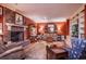 Spacious living room featuring a brick fireplace, hardwood floors, and custom built-in shelving at 1716 Club Circle Dr., Pawleys Island, SC 29585