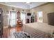 Main bedroom with hardwood floors, television, writing desk, and ensuite bathroom access at 1716 Club Circle Dr., Pawleys Island, SC 29585