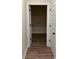 Hallway with wood floors leading to storage room and white doors with black handles at 3162 Wayside Rd., Conway, SC 29527