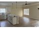 Open-concept kitchen featuring white cabinetry, a large island, and modern ceiling fan at 3162 Wayside Rd., Conway, SC 29527