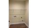 Bright laundry room with wire shelving, utility connections, and wood-look flooring at 3162 Wayside Rd., Conway, SC 29527