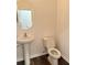 Powder room with pedestal sink, oval mirror, and toilet at 8640 Farrier Dr., Myrtle Beach, SC 29588