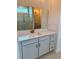 Stylish bathroom vanity with blue-gray cabinets, quartz countertop, rectangular mirror, and modern gold faucet at 8640 Farrier Dr., Myrtle Beach, SC 29588