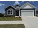 Charming home featuring navy blue siding, white trim, and a spacious two-car garage at 8640 Farrier Dr., Myrtle Beach, SC 29588