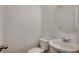 Neutral half bathroom featuring a pedestal sink and round mirror at 8648 Farrier Dr., Myrtle Beach, SC 29588