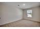 A spacious bedroom with neutral carpet, a window, and ample natural light at 8648 Farrier Dr., Myrtle Beach, SC 29588