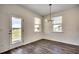Bright dining area with modern lighting, views, and wood-look floors at 8648 Farrier Dr., Myrtle Beach, SC 29588