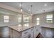 Open floorplan shows granite kitchen island with pendant lighting and hardwood floors at 8648 Farrier Dr., Myrtle Beach, SC 29588