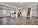 Spacious living area showcasing an open floor plan with kitchen and staircase at 8648 Farrier Dr., Myrtle Beach, SC 29588