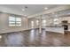 Open-concept living room with wood-look floors, neutral walls, and lots of natural light at 8648 Farrier Dr., Myrtle Beach, SC 29588
