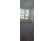 A sunlit bedroom featuring a large window with views of the neighborhood at 8652 Farrier Dr., Myrtle Beach, SC 29588