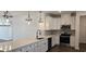 Bright kitchen featuring stainless steel appliances, quartz countertops, stylish backsplash, and pendant lights at 8652 Farrier Dr., Myrtle Beach, SC 29588