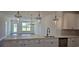 Open-concept kitchen featuring white cabinets, stainless steel appliances, quartz counters, and an island bar at 8652 Farrier Dr., Myrtle Beach, SC 29588