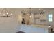 Modern kitchen with white cabinets, quartz countertops, pendant lighting, and stainless steel appliances at 8652 Farrier Dr., Myrtle Beach, SC 29588