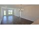 Open-concept living room with hardwood floors, ample natural light, and modern chandelier lighting at 8652 Farrier Dr., Myrtle Beach, SC 29588