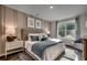 Serene bedroom featuring a plush bed, stylish decor, ample natural light, and a cozy seating area at 8663 Farrier Dr., Myrtle Beach, SC 29588