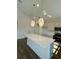 Bright, updated kitchen with white marble countertops, pendant lights, and stainless-steel appliances at 8663 Farrier Dr., Myrtle Beach, SC 29588