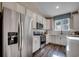 Well-equipped kitchen features stainless steel appliances, white cabinetry, and a bright window at 8663 Farrier Dr., Myrtle Beach, SC 29588