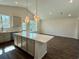 Well-lit kitchen with a large island, stainless steel appliances, and ample counter space at 8663 Farrier Dr., Myrtle Beach, SC 29588