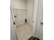 An empty laundry room with tile floor and a metal shelf above the water hookups at 8663 Farrier Dr., Myrtle Beach, SC 29588